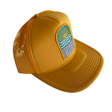 Yellow cap with a mesh back and logo on a white background