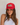 A woman wearing a red trucker-style cap with a white front patch that reads 'Spicy' in green script with a red chili pepper graphic, posed against a light textured wall.