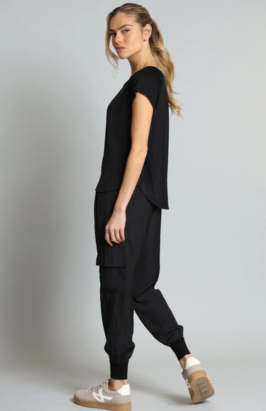 Woman wearing a black outfit with a plain background