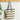Woven tote bag with black stripes hanging on a wooden hook against a white wall.