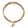 Multicolored beaded bracelet with a tassel charm on a white background