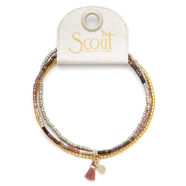 Set of beaded bracelets with a tassel charm on a Scout branded card.