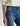 Close-up of blue jeans featuring side pocket details with a neutral background