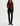 A woman wearing slim straight jeans in black with black boots and a maroon long sleeve tee on a white background.