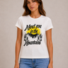 A white basic tee with “Meet Me in the Mountians” written on the front