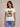 A white basic tee with “Meet Me in the Mountians” written on the front