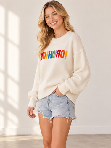 A woman wearing a white sweater with “HO!HO!HO!” written along the arms and shoulders in colorful letters.