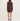 A woman viewed from the back wearing a dark brown ribbed knit long-sleeve mini dress with a collar, paired with black heeled sandals, against a plain off-white studio background.