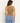 a woman wearing a cocoa shine crop tank with ruched side detailing on a white background 