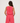 Woman wearing a pink sleeveless top and pants on a white background