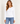 A woman wearing a white crew neck long sleeve on a white background