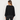 A woman shown from the back wearing a black long-sleeve top with balloon sleeves and dark gray jeans, photographed against a plain light gray studio background.