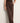 A woman wearing brown knit pants on a white  background