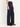 A model facing sideways wearing navy wide leg pants and a white tee on a white background.