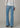 A woman wearing light blue high rise flare jeans