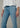 A woman wearing light blue high rise jeans