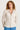 Woman wearing a beige jacket with a white background
