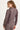 Woman wearing a brown jacket on a white background