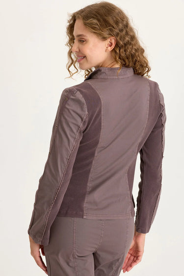 Woman wearing a brown jacket on a white background