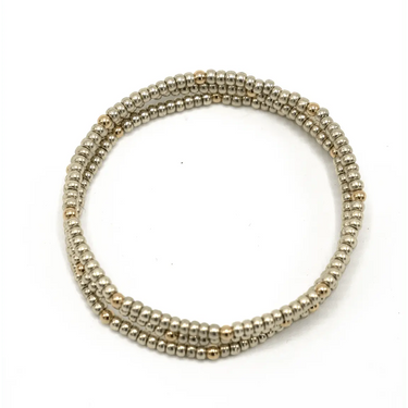 Beaded platinum bracelet with gold filled beads on a white background