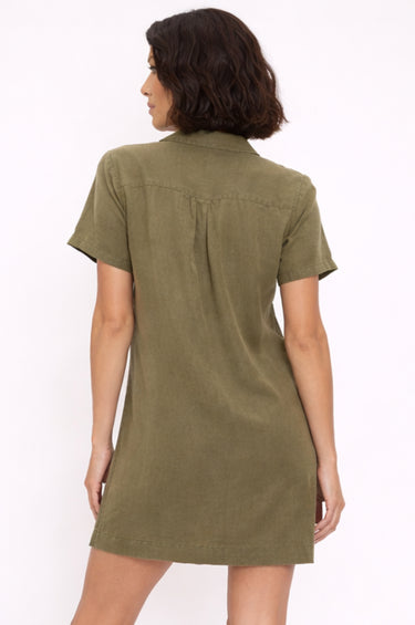Woman wearing an olive green dress on a white background