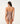 A woman wearing a shiny halter cocoa swimsuit on a white background.