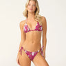 A woman wearing purple bikini with an embroidered floral pattern on a white background