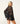 A model wearing a black bikini under a black lace long-sleeve tunic cover-up with scalloped pattern, lace-up V-neck and tassel ties.