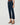 A model wearing dark blue cropped straight-leg jeans with brown wedge sandals, shown from the waist down against a light gray studio background.