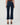 A person shown from the back wearing dark blue cropped flare jeans with a brown top and brown wedge sandals against a light gray studio background.