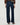 Rear view of a model wearing dark blue wide-leg jeans with a brown blouse and brown shoes, against a light gray studio background.