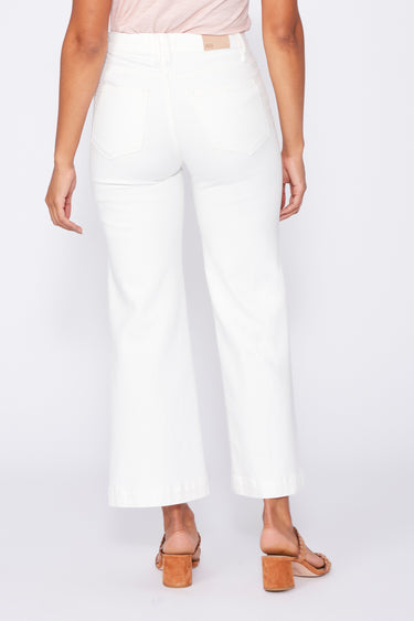 Person wearing white wide-leg pants on a plain background