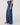 Person wearing blue jeans on a plain background