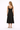 Woman wearing a black sleeveless dress on a white background