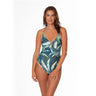 Woman wearing a tropical leaf patterned swimsuit on a white background