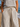 Person wearing a striped shirt and pants with a blurred beach background