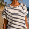 Woman wearing a striped shirt on a beach