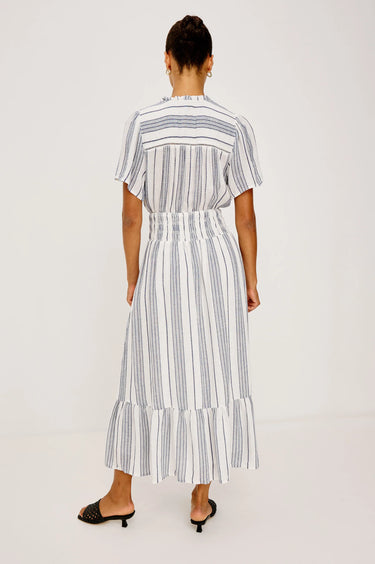 Woman wearing a striped dress on a white background