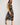 Woman wearing a patterned dress on a white background