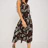 Woman wearing a patterned dress on a white background