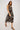 Woman wearing a patterned dress on a white background