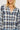 Plaid shirt worn by a person on a white background
