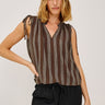 Woman wearing a brown striped sleeveless top and black pants on a white background