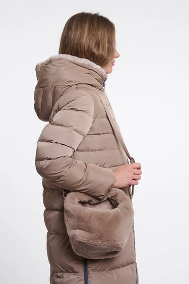 Woman wearing a brown puffer jacket with fur-lined hood on a white background