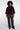 Woman wearing a brown fur coat and black leather pants on a white background