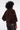 Person wearing a brown fur jacket on a white background