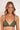 Woman wearing a green bikini top against a plain background