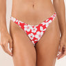 A woman wearing a Hawaiian floral red bikini bottom