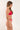 Woman wearing a red bikini against a white background