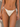 White bikini bottom with ruffled details on a neutral background